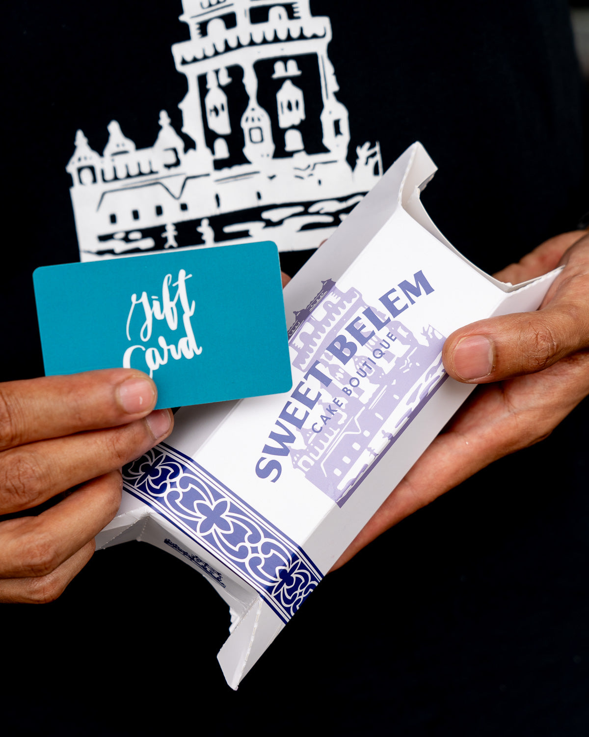 Person holding a teal gift card and a white box with 'Sweet Belem' branding.